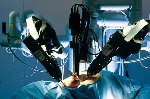 Machine arms get to work in the operating theatre